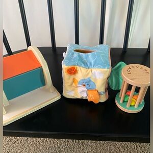 Montessori toys - wooden spinning wheel, tissue box toy, and lovevery rattle